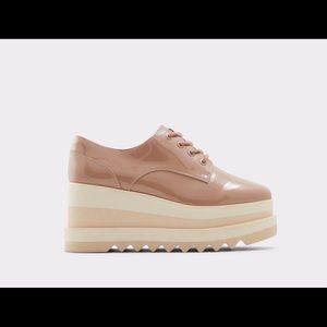 Nude Amond toe oxfords grounded on a flatform.